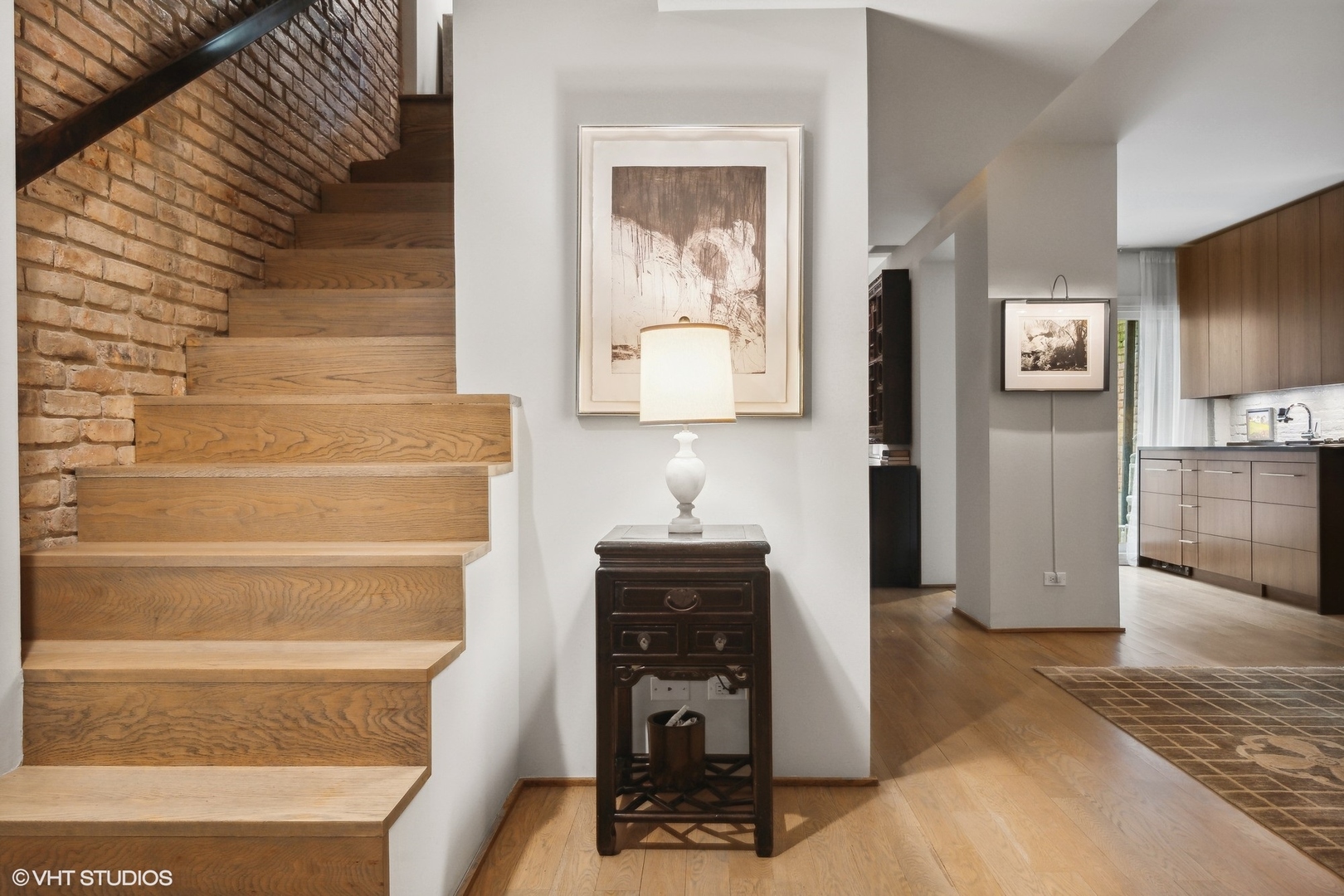 24 East Division Street Chicago, IL 60610 - Photo 8 of 52 a view of a hallway with wooden floor and a cabinet