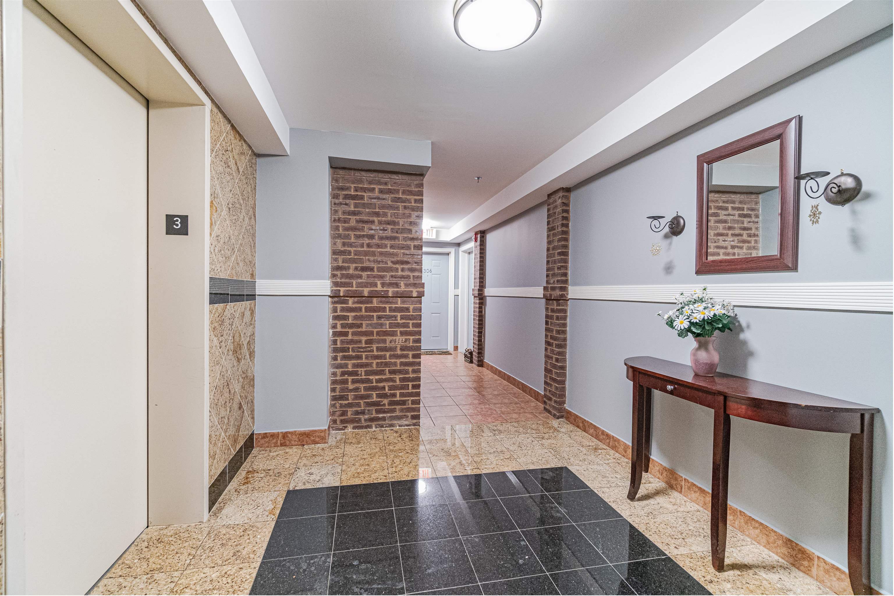135 38th Street, Unit 302 Union City, NJ 07087 - Photo 2 of 18 a view of hallway with wooden floor and stairs