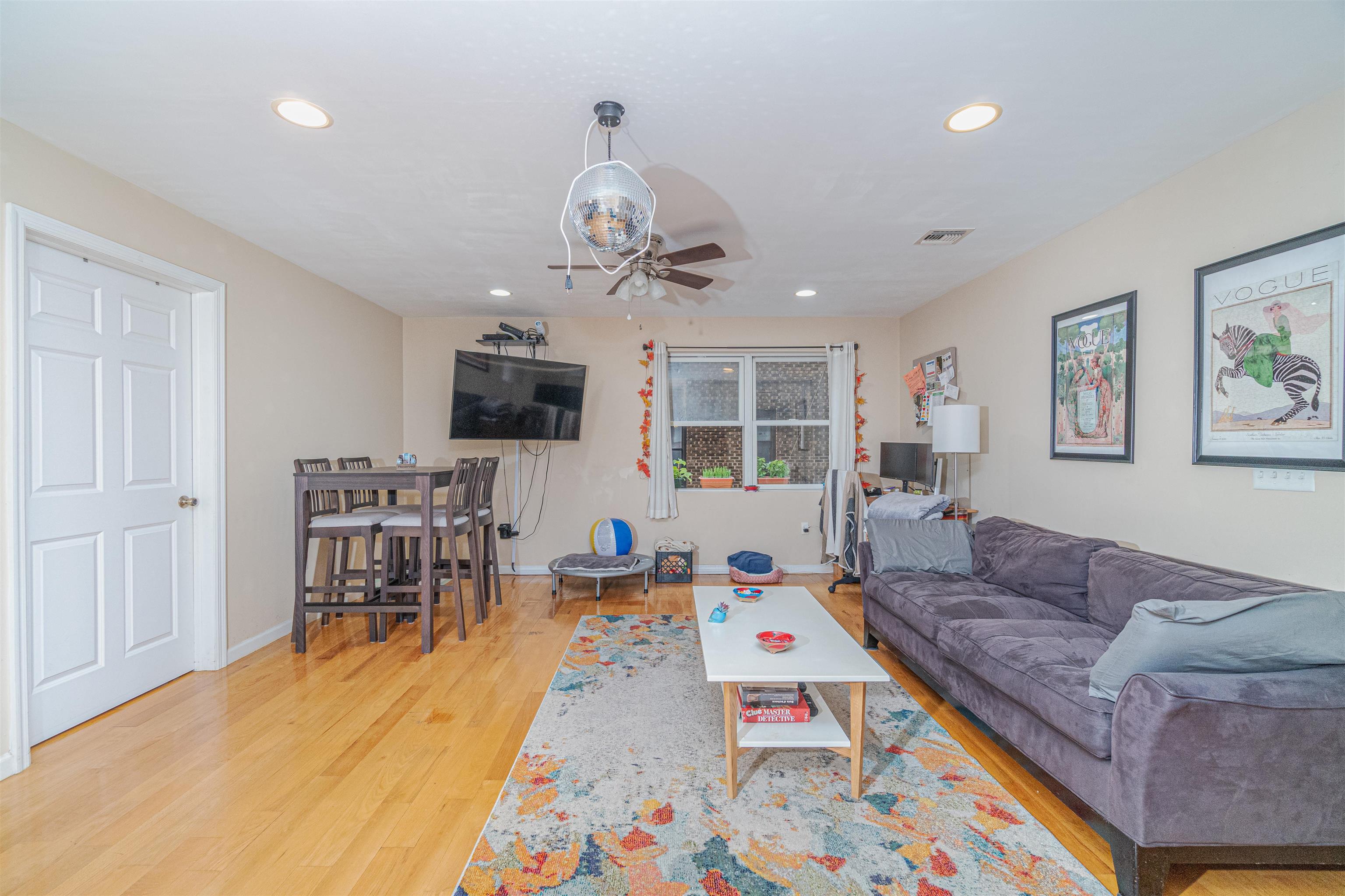 135 38th Street, Unit 302 Union City, NJ 07087 - Photo 3 of 18 a living room with furniture wooden floor and a flat screen tv
