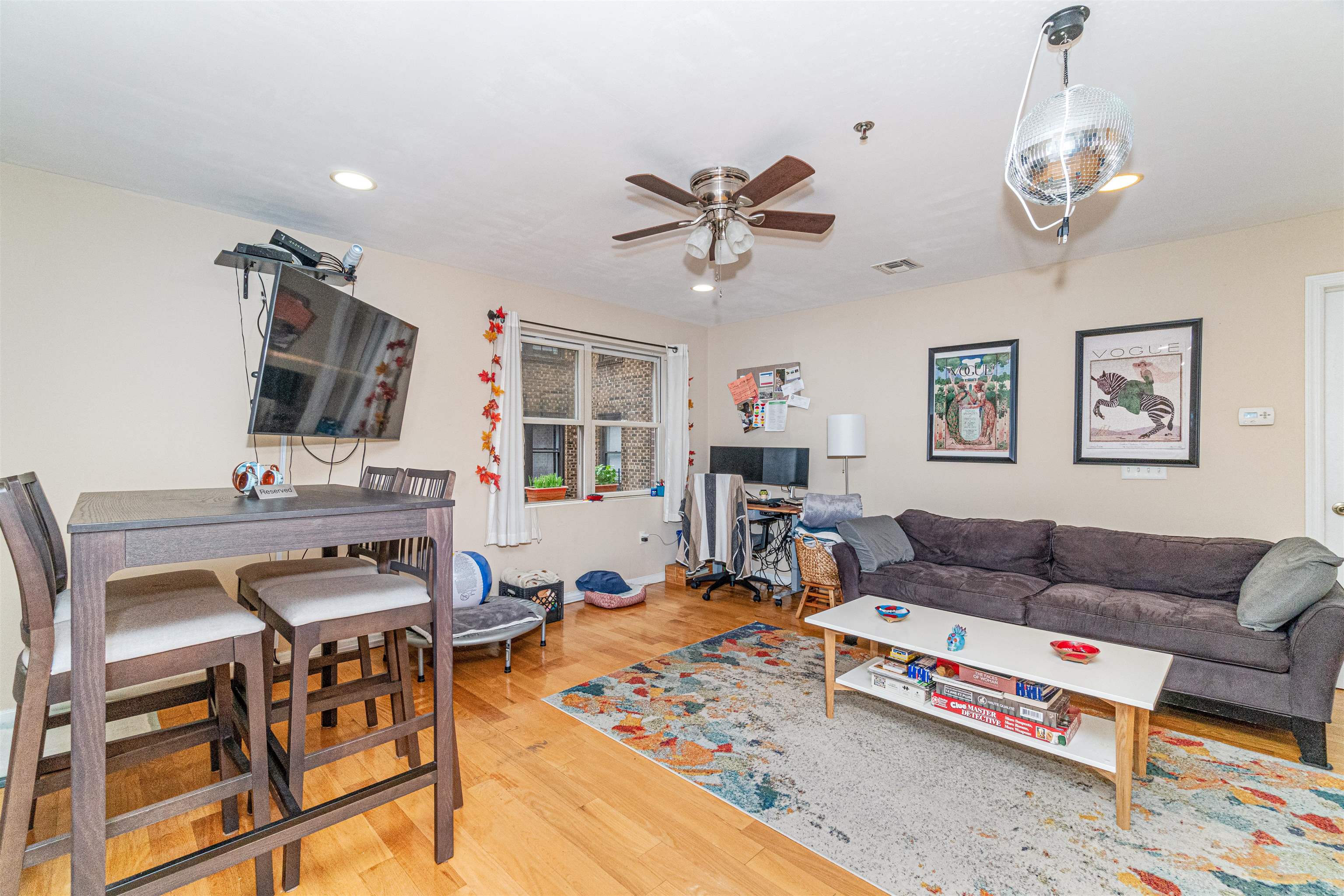 135 38th Street, Unit 302 Union City, NJ 07087 - Photo 4 of 18 a living room with furniture and wooden floor