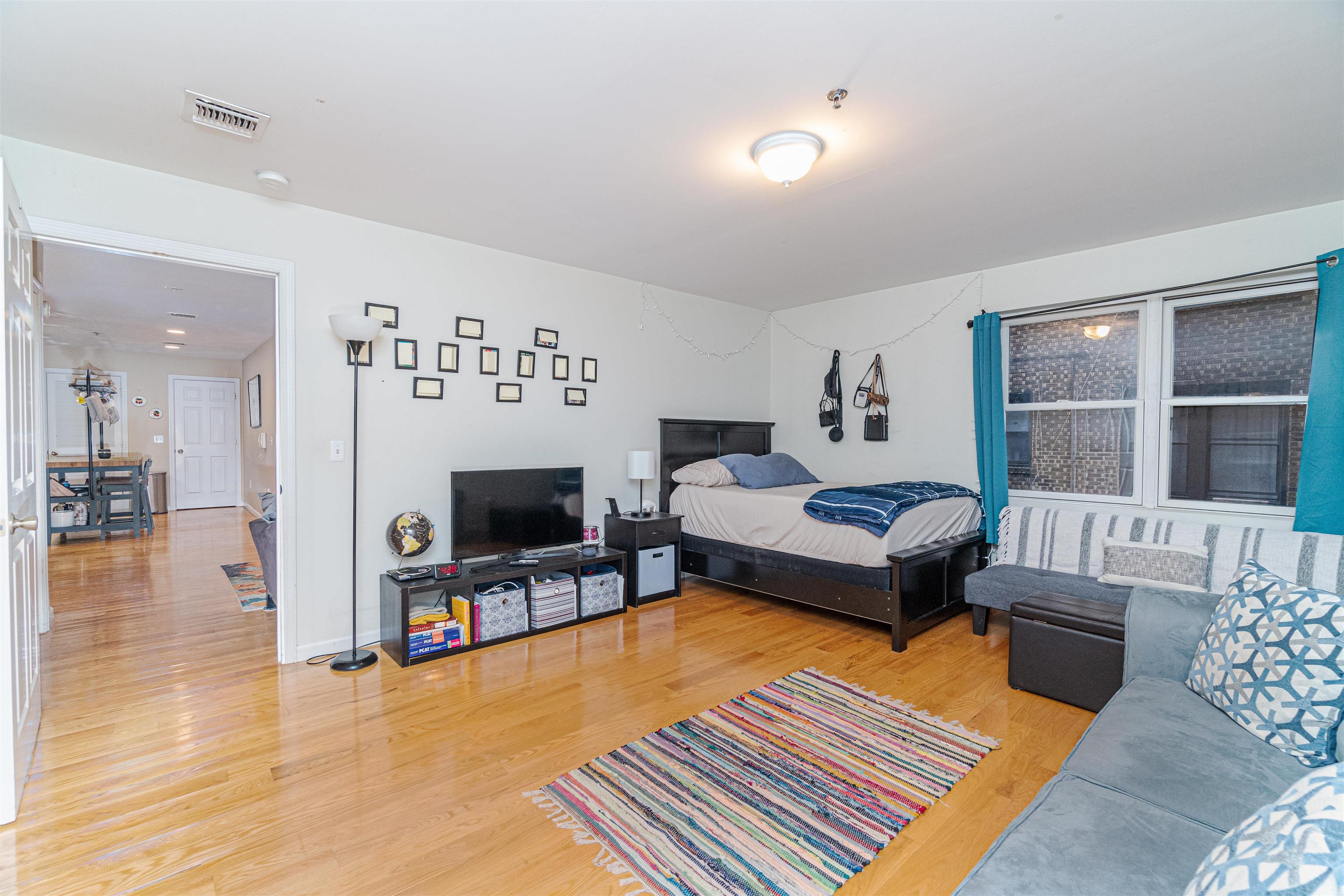 135 38th Street, Unit 302 Union City, NJ 07087 - Photo 5 of 18 a bedroom with furniture and a fireplace