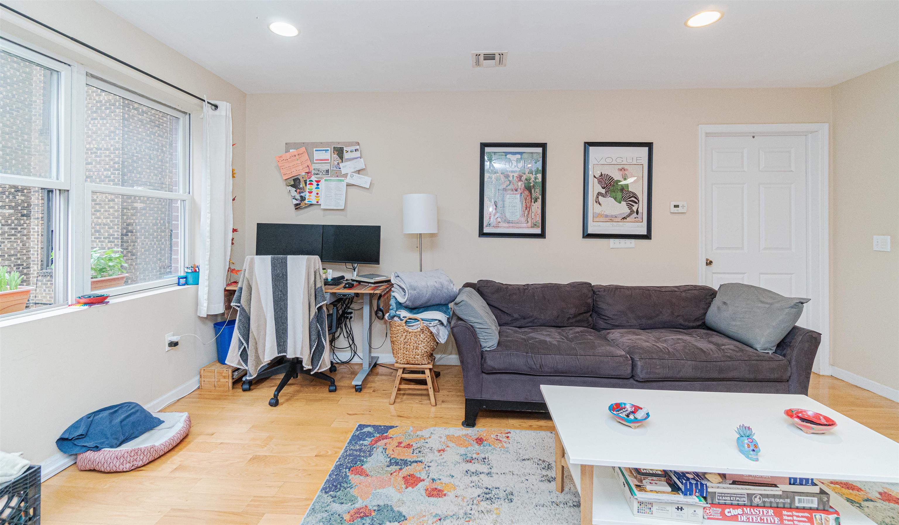 135 38th Street, Unit 302 Union City, NJ 07087 - Photo 6 of 18 a living room with furniture and a flat screen tv