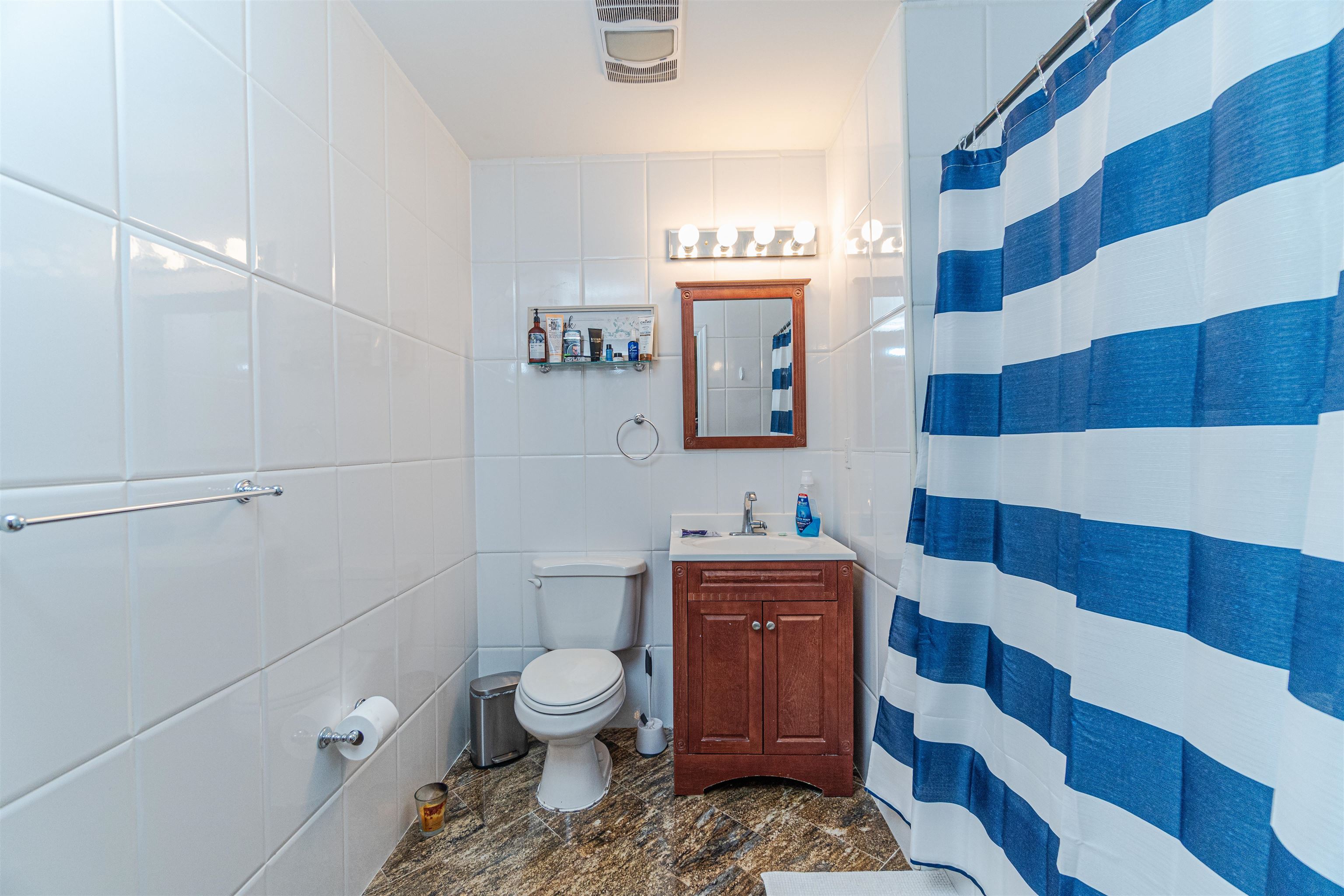 135 38th Street, Unit 302 Union City, NJ 07087 - Photo 7 of 18 a bathroom with a sink a toilet and a mirror