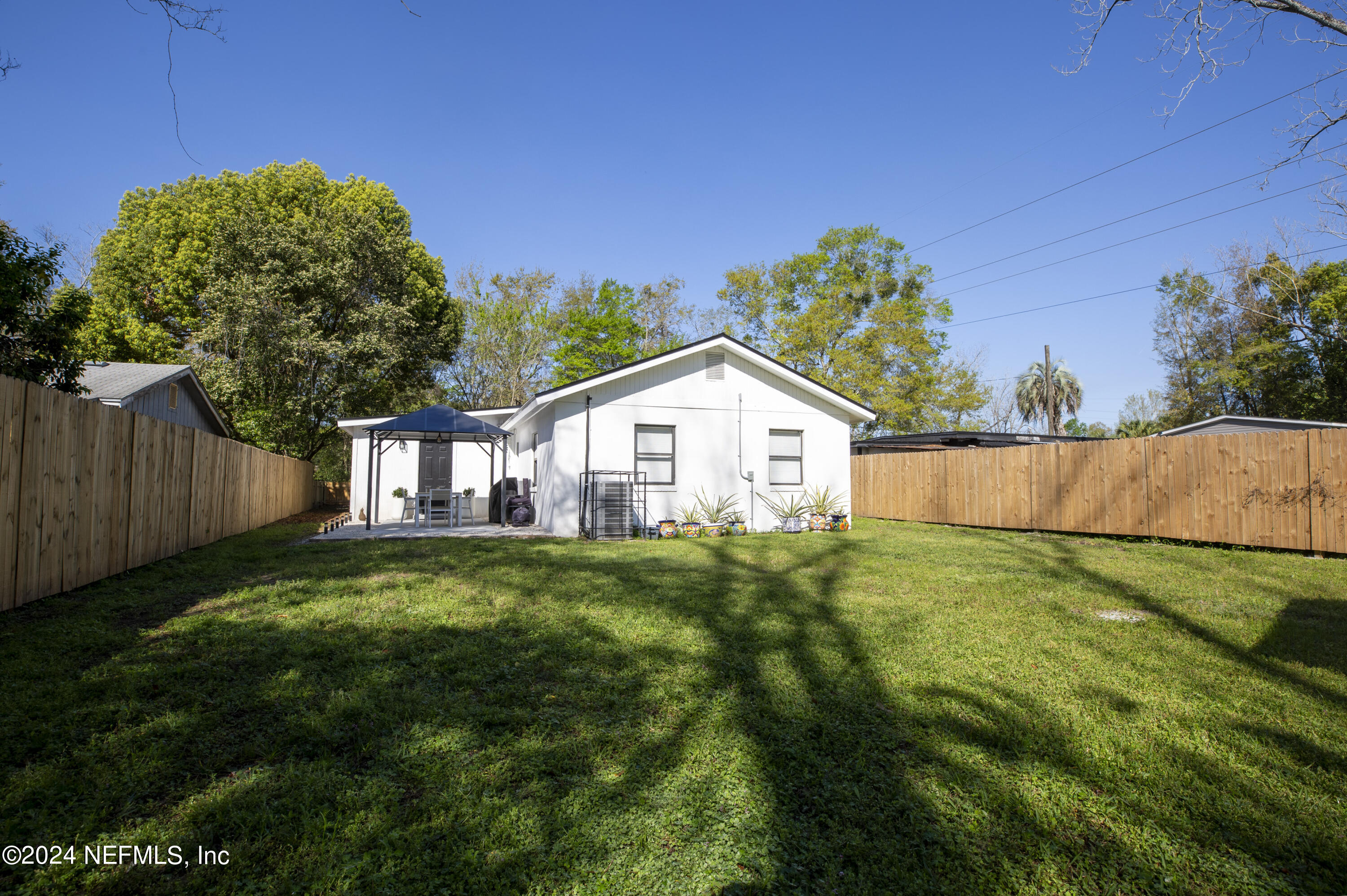 1067 Cahoon Road South Jacksonville, FL 32221 - Photo 21 of 21 a backyard of a house with plants and wooden fence