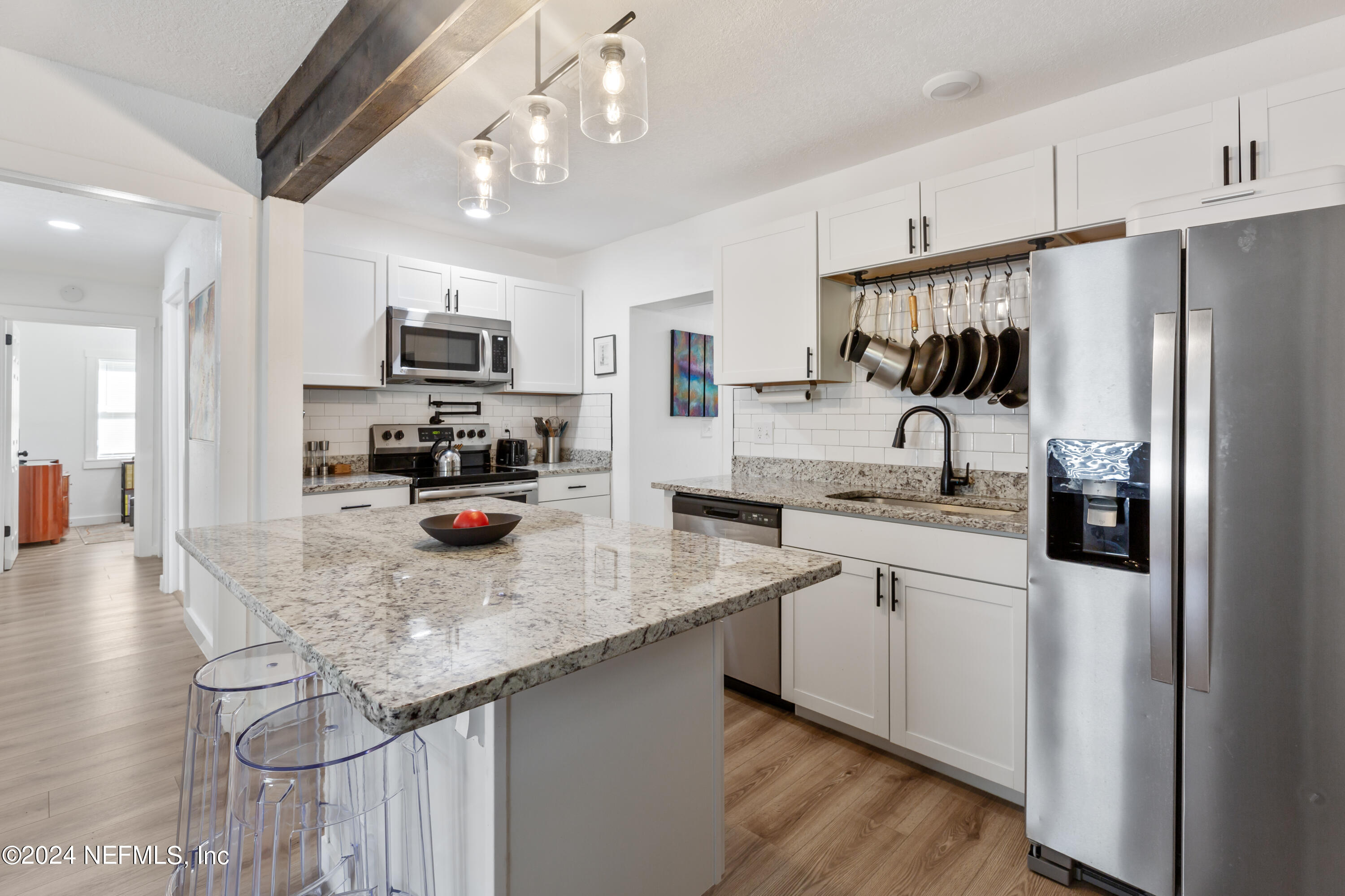 1067 Cahoon Road South Jacksonville, FL 32221 - Photo 3 of 21 a kitchen with stainless steel appliances granite countertop a sink refrigerator and microwave