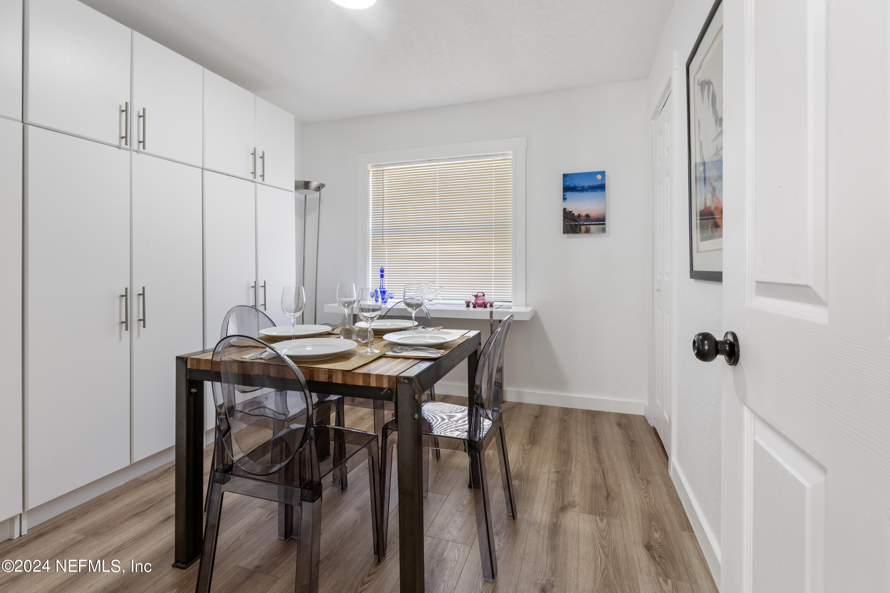 1067 Cahoon Road South Jacksonville, FL 32221 - Photo 7 of 21 a view of a dining room with furniture and wooden floor