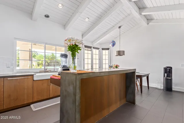 a living room with furniture a window and potted plant