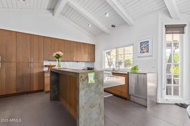 a kitchen with granite countertop a refrigerator and a stove