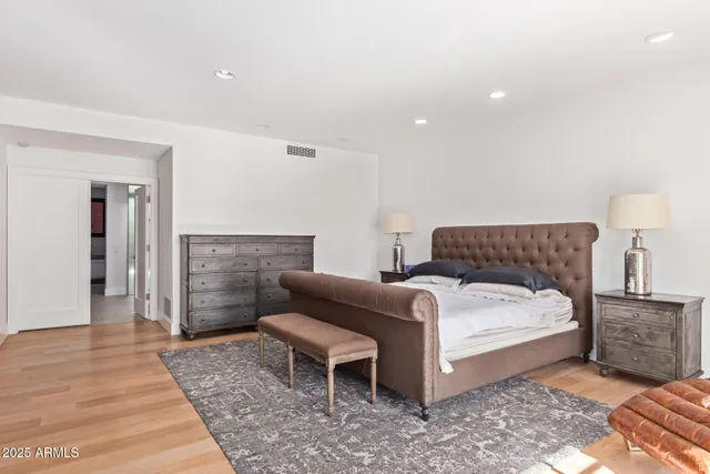 a spacious bedroom with a bed and a couch