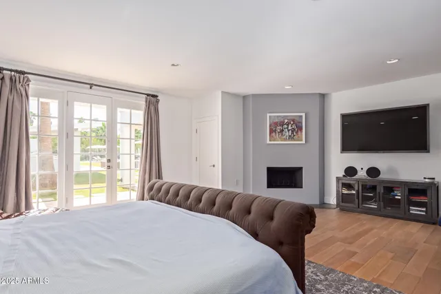 a spacious bedroom with a bed and a television