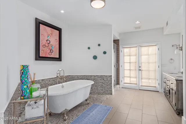 a bathroom with a granite countertop sink a toilet and a tub
