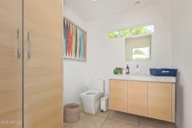 a bathroom with a toilet sink and mirror