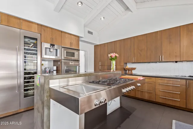 a kitchen with stainless steel appliances granite countertop a sink stove and refrigerator