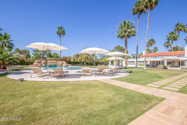 a view of a swimming pool with an outdoor seating