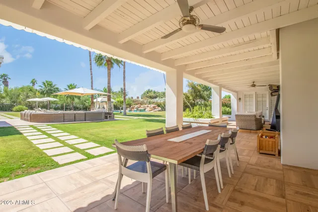 a view of a patio with table and chairs potted plants with wooden floor