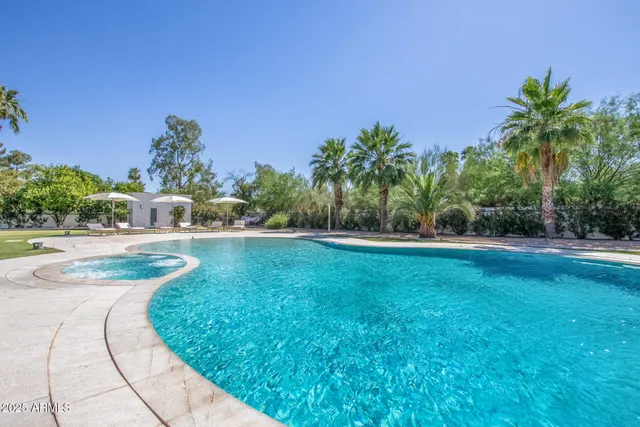 a view of a swimming pool with a yard