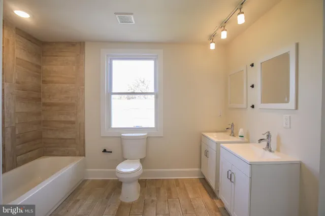 a bathroom with a sink a toilet and a bathtub