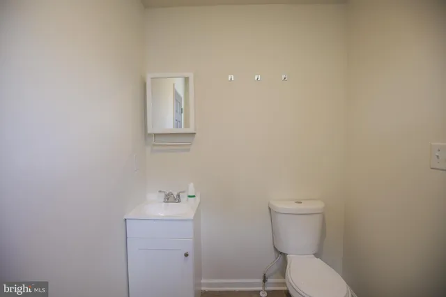 a white toilet sitting next to a bathroom sink