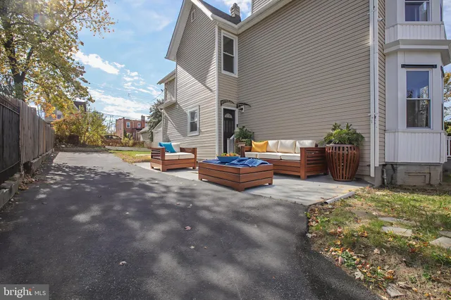 a backyard of a house with fire pit and outdoor seating