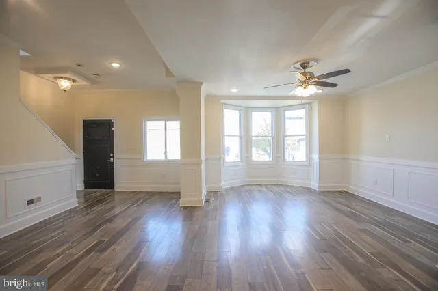 wooden floor in an empty room with a window