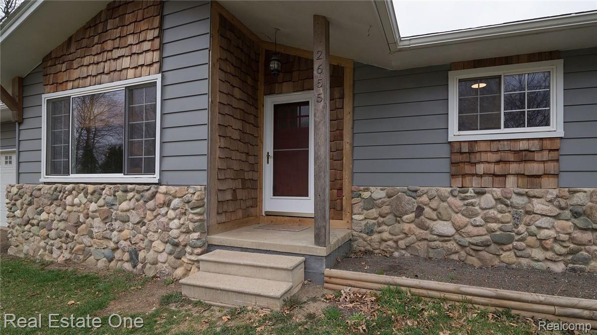 2655 Porter Road White Lake, MI 48383 - Photo 2 of 39 Charming stone and cedar shake accents.