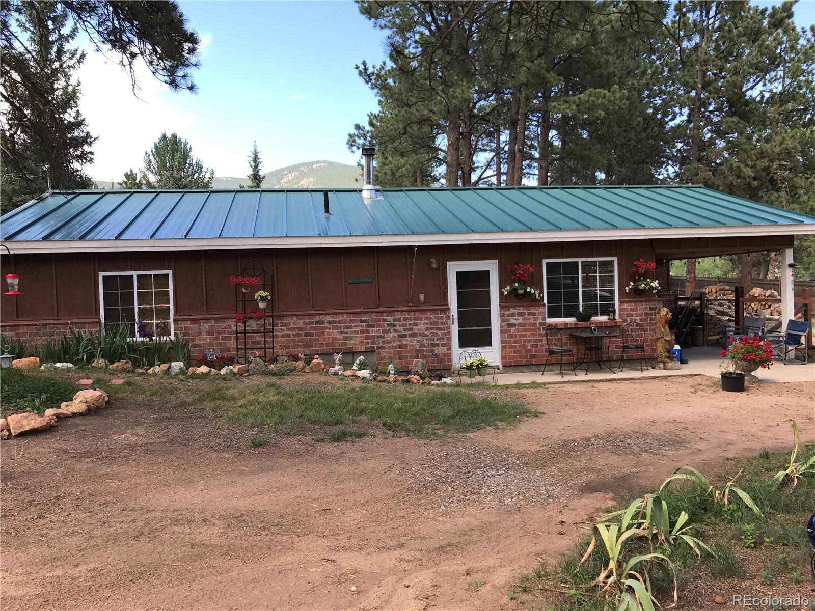 161 Sullivan Street Bailey, CO 80421 - Photo 1 of 32 a view of a house with backyard and sitting area