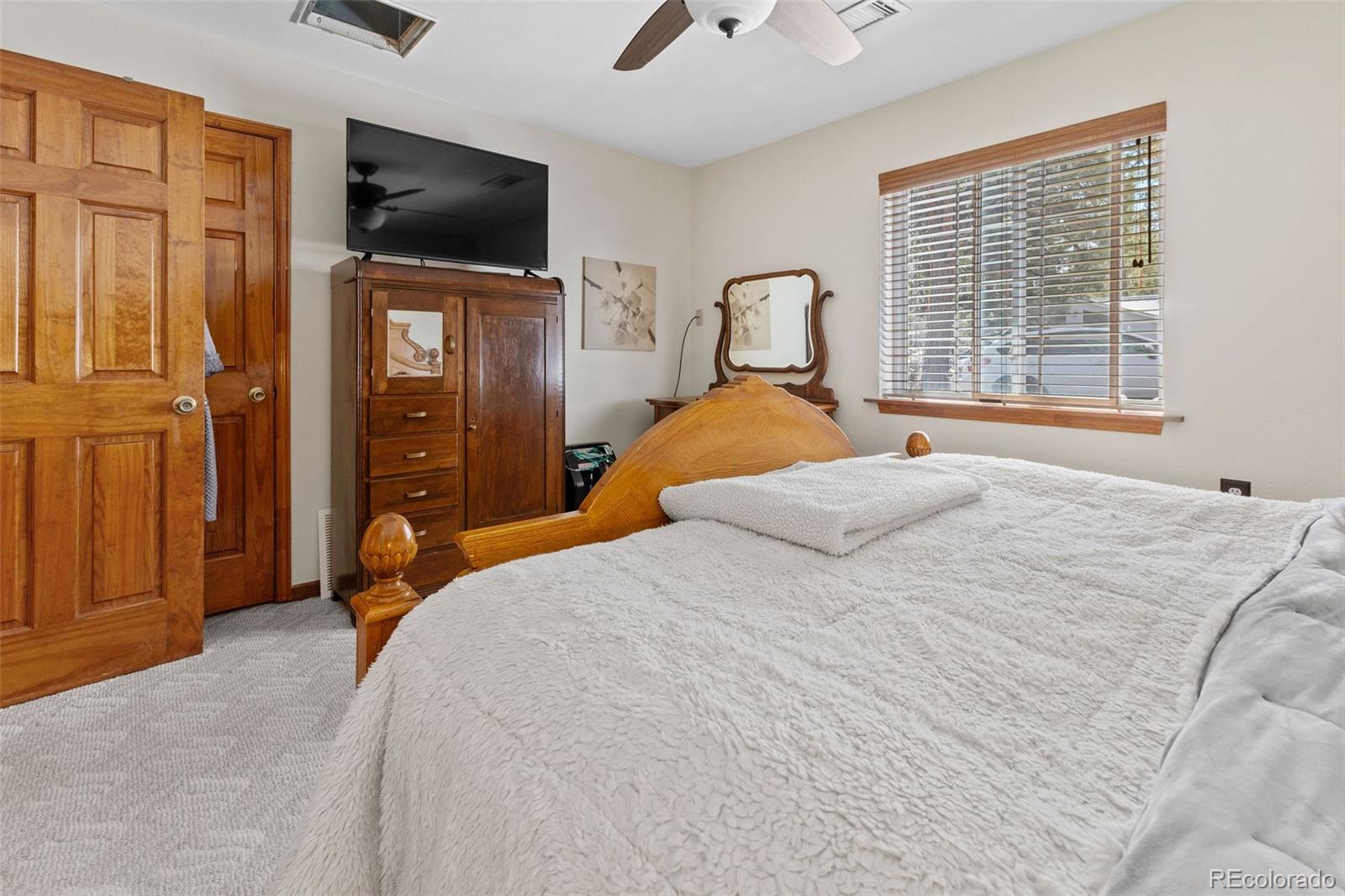 161 Sullivan Street Bailey, CO 80421 - Photo 11 of 32 a bedroom with a bed and a flat screen tv