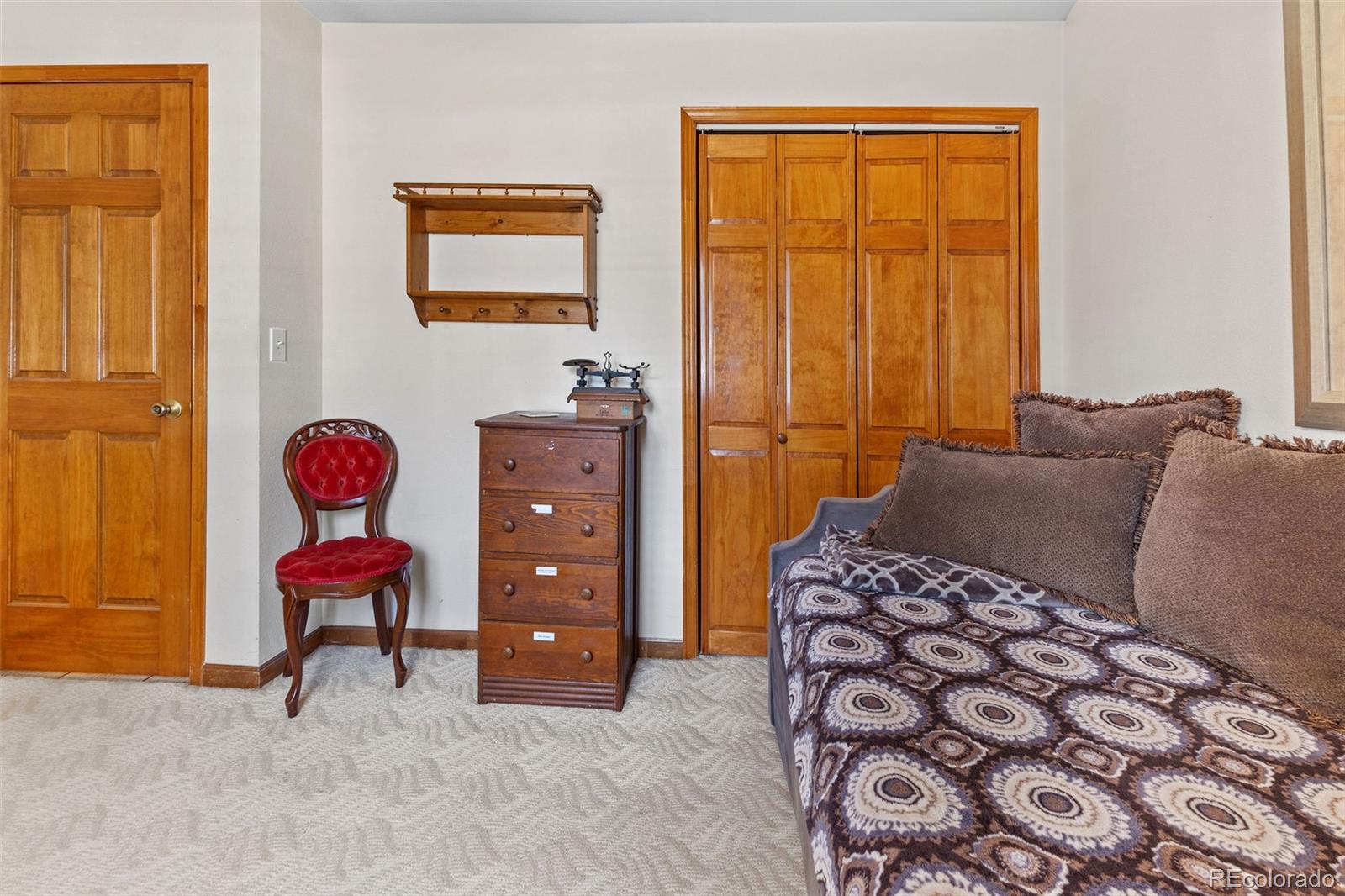 161 Sullivan Street Bailey, CO 80421 - Photo 14 of 32 a bedroom with a bed and a chair
