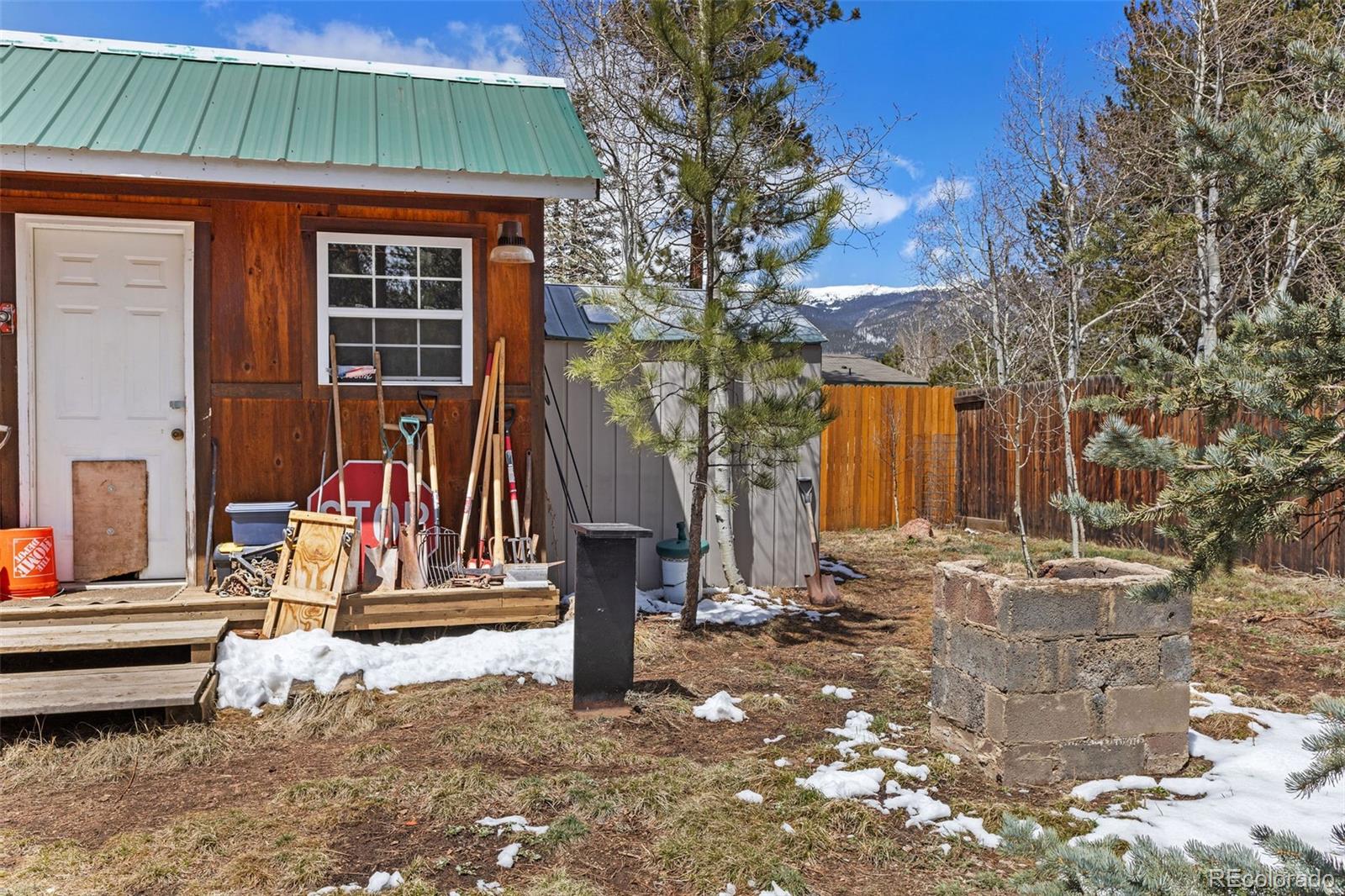 161 Sullivan Street Bailey, CO 80421 - Photo 23 of 32 a backyard of a house with barbeque oven table and chairs