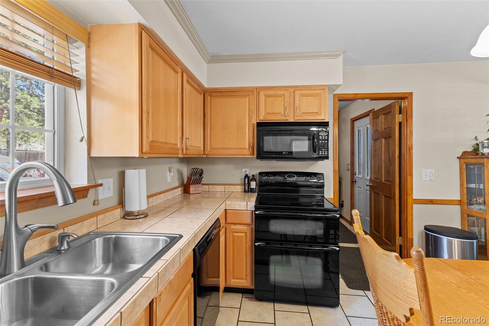161 Sullivan Street Bailey, CO 80421 - Photo 7 of 32 a kitchen with granite countertop a sink and steel appliances