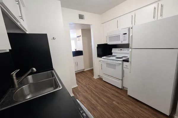 a kitchen with a refrigerator and a sink