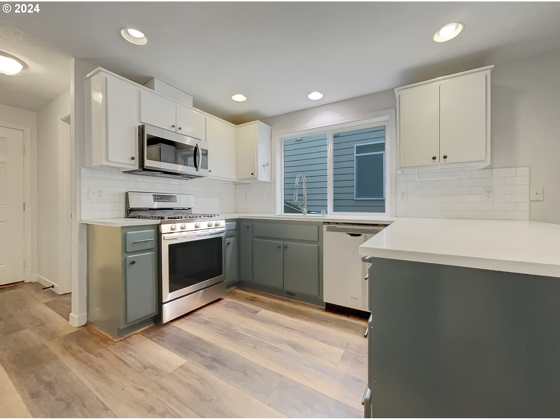 2933 South Cedar Ridge Drive Ridgefield, WA 98642 - Photo 21 of 21 a kitchen with stainless steel appliances a white stove top oven cabinets and a refrigerator
