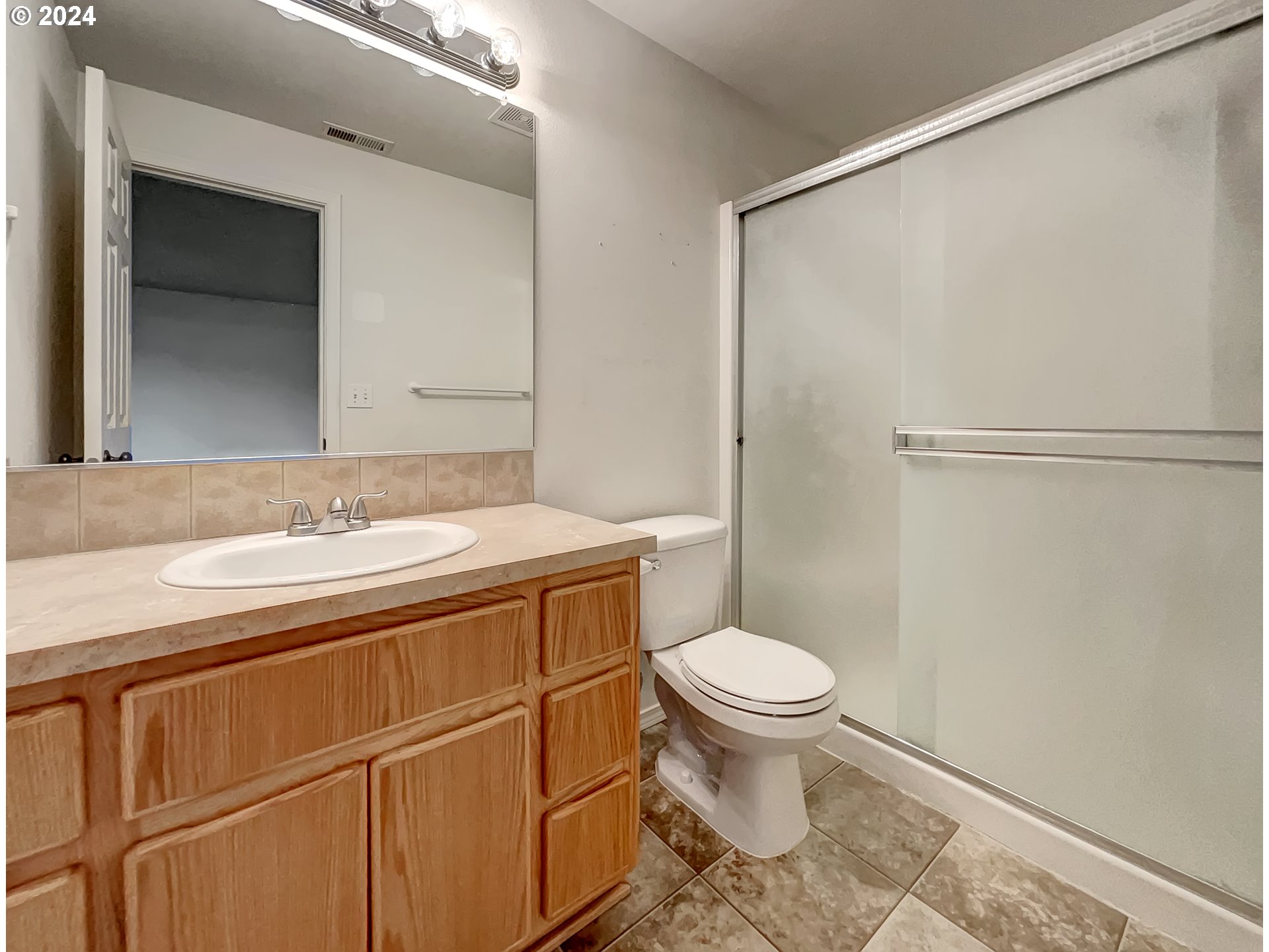 2933 South Cedar Ridge Drive Ridgefield, WA 98642 - Photo 9 of 21 a bathroom with a granite countertop sink toilet and a mirror