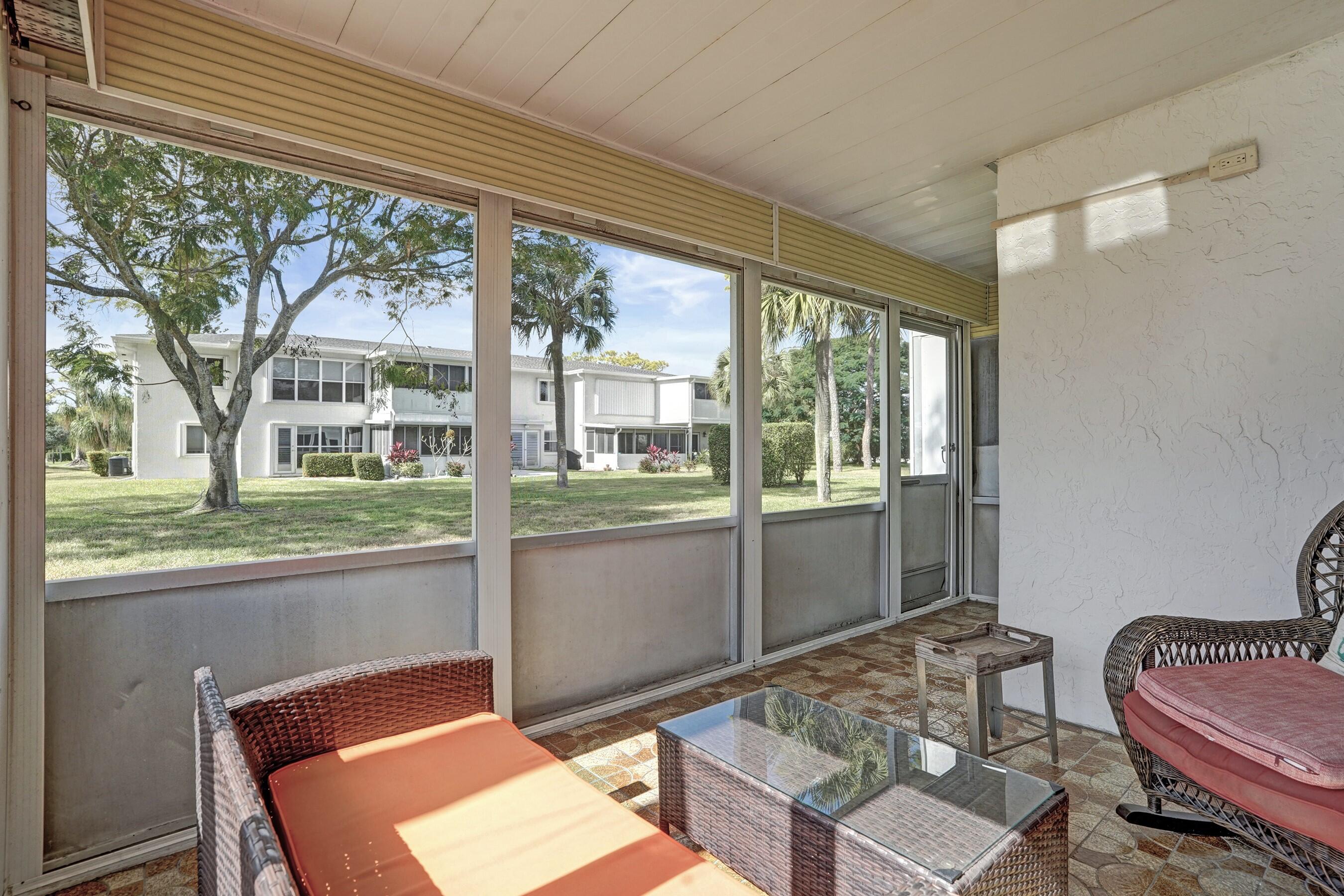 1435 Southwest 27th Avenue, Unit 101 Delray Beach, FL 33445 - Photo 3 of 59 Screened patio