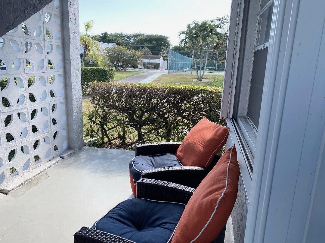 1435 Southwest 27th Avenue, Unit 101 Delray Beach, FL 33445 - Photo 4 of 59 Under roof front patio