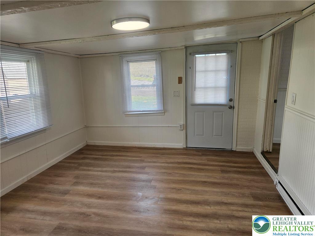 23 West Ruddle Street Coaldale, PA 18218 - Photo 7 of 16 a view of an empty room with wooden floor and a window