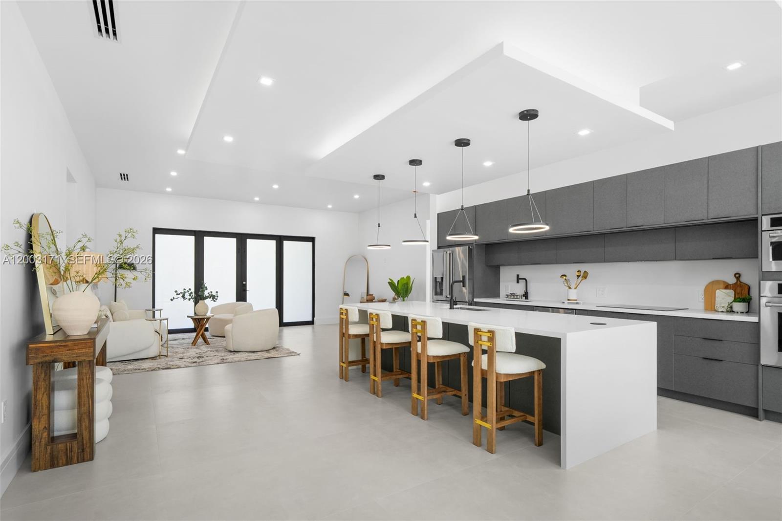 29705 Southwest 187th Avenue Homestead, FL 33030 - Photo 2 of 55 a large white kitchen with lots of counter space and stainless steel appliances