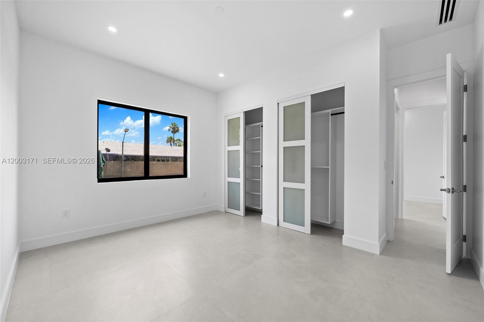 29705 Southwest 187th Avenue Homestead, FL 33030 - Photo 22 of 55 an empty room with a empty space and windows