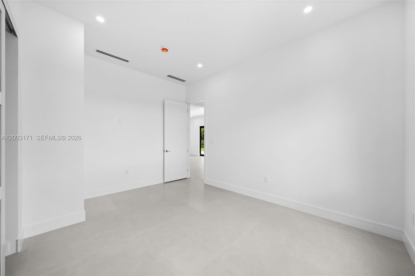 29705 Southwest 187th Avenue Homestead, FL 33030 - Photo 24 of 55 an empty room with an entryway and fan