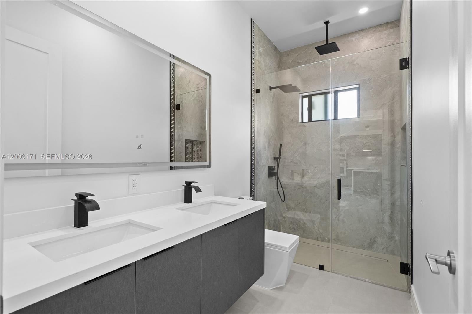 29705 Southwest 187th Avenue Homestead, FL 33030 - Photo 25 of 55 a bathroom with a sink a toilet and shower