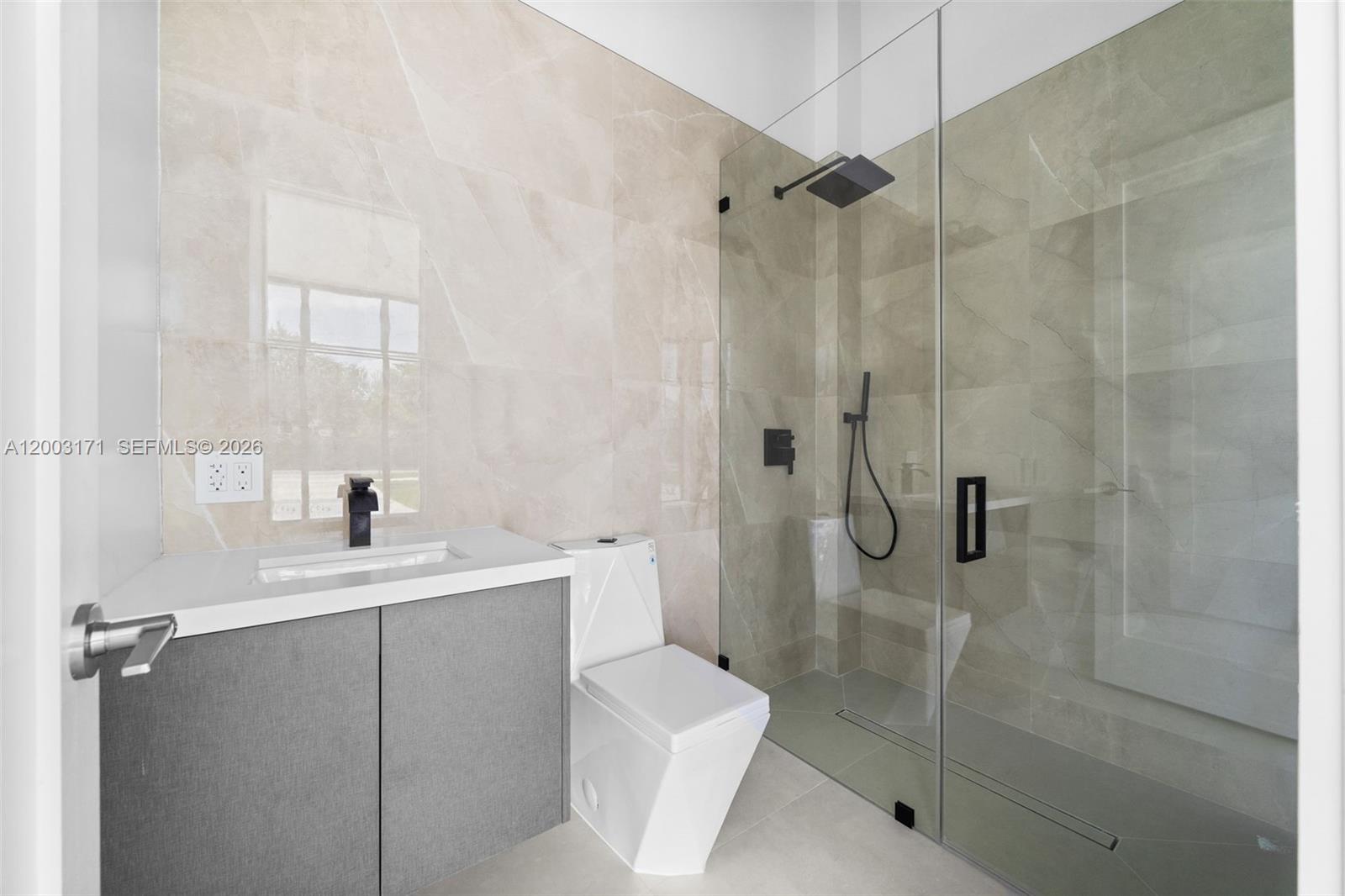 29705 Southwest 187th Avenue Homestead, FL 33030 - Photo 26 of 55 a bathroom with a sink a toilet and shower