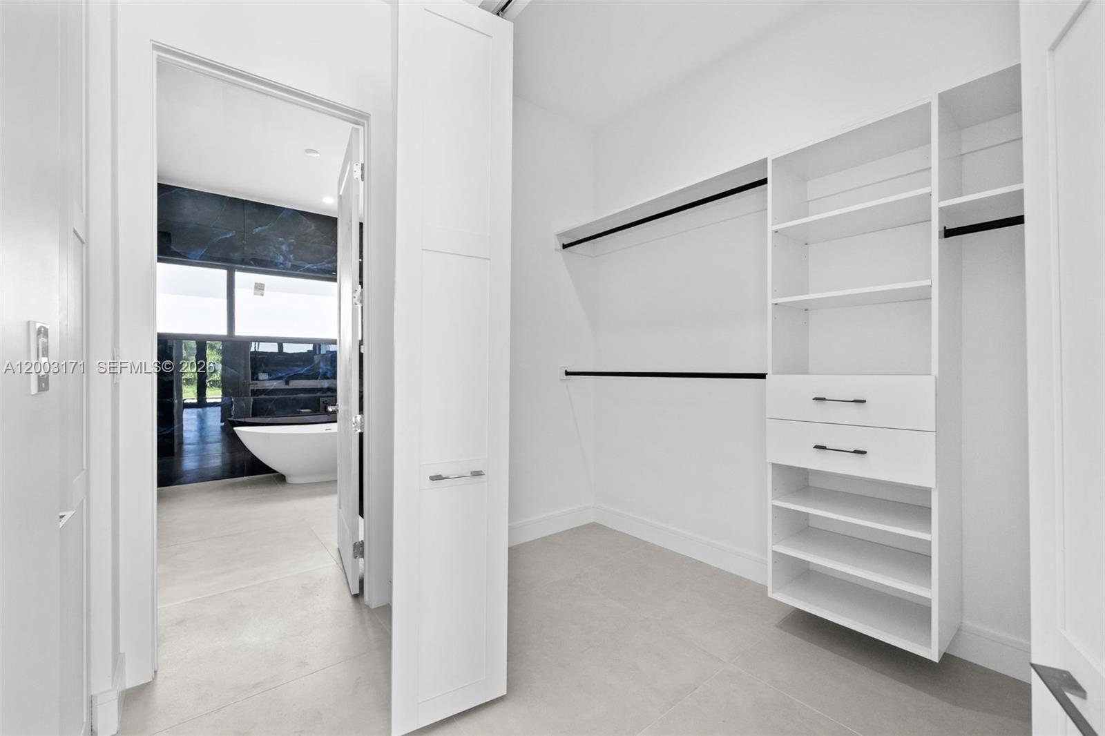 29705 Southwest 187th Avenue Homestead, FL 33030 - Photo 32 of 55 a view of an empty walk in closet and a window
