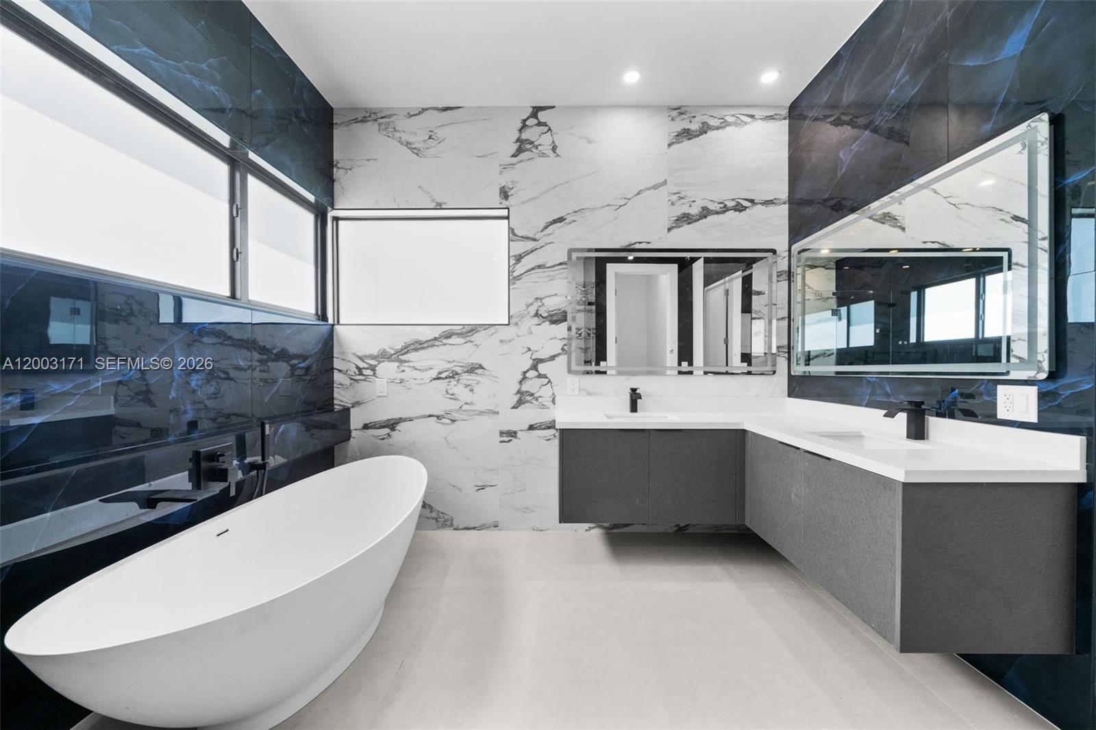 29705 Southwest 187th Avenue Homestead, FL 33030 - Photo 34 of 55 a bathroom with a bathtub sink mirror and toilet