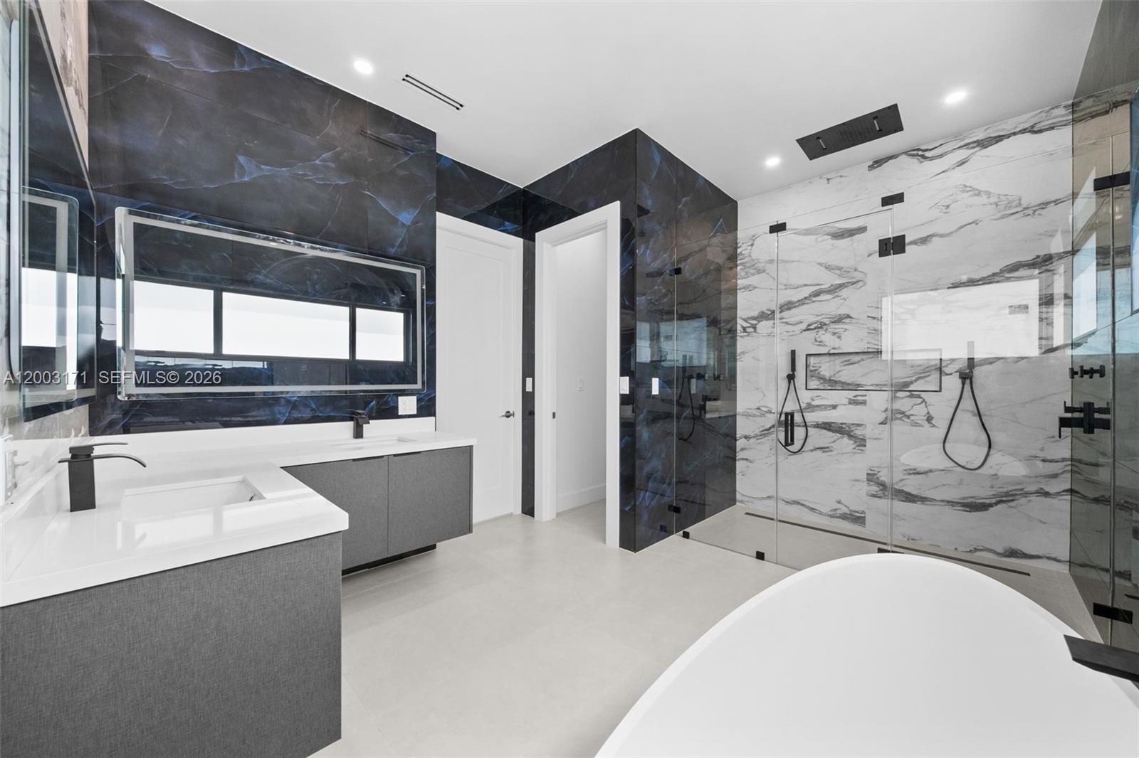 29705 Southwest 187th Avenue Homestead, FL 33030 - Photo 35 of 55 a bathroom with a tub sink and mirror