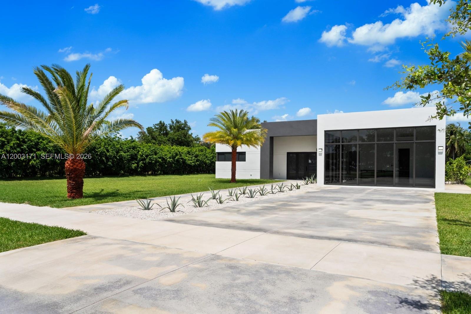 29705 Southwest 187th Avenue Homestead, FL 33030 - Photo 36 of 55 a house with a garden in front of it