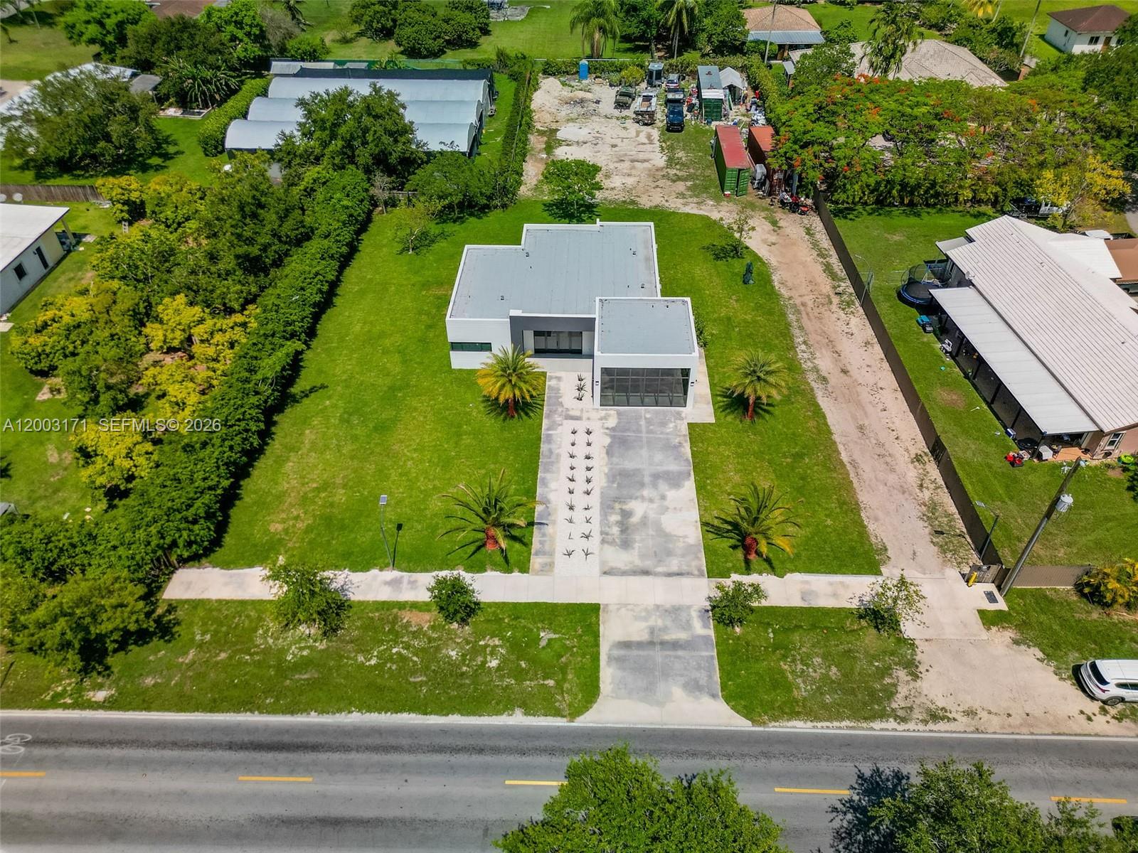 29705 Southwest 187th Avenue Homestead, FL 33030 - Photo 46 of 55 an aerial view of a house with a yard and lake view