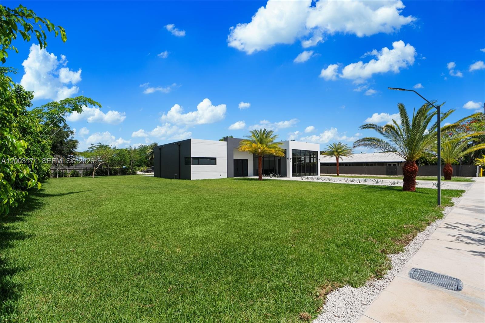 29705 Southwest 187th Avenue Homestead, FL 33030 - Photo 50 of 55 a view of a house with a yard