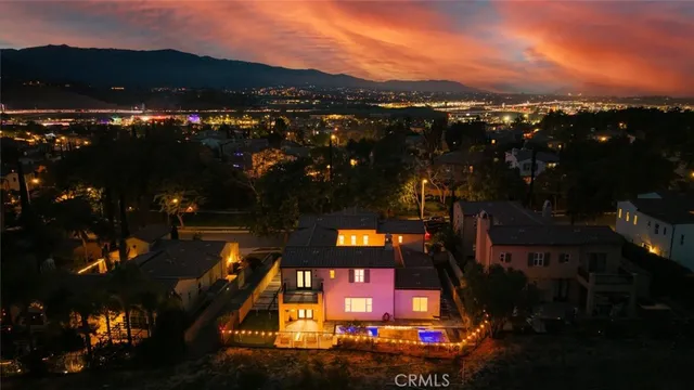 a living room with furniture a flat screen tv and a table
