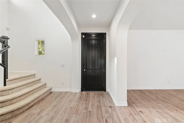 a kitchen with stainless steel appliances granite countertop a sink stove and wooden floor
