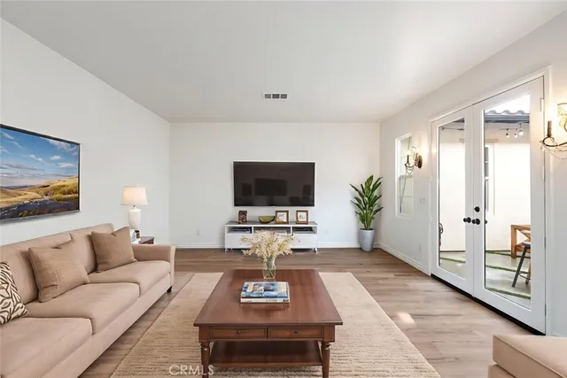 a kitchen with granite countertop a table chairs stove and wooden floor